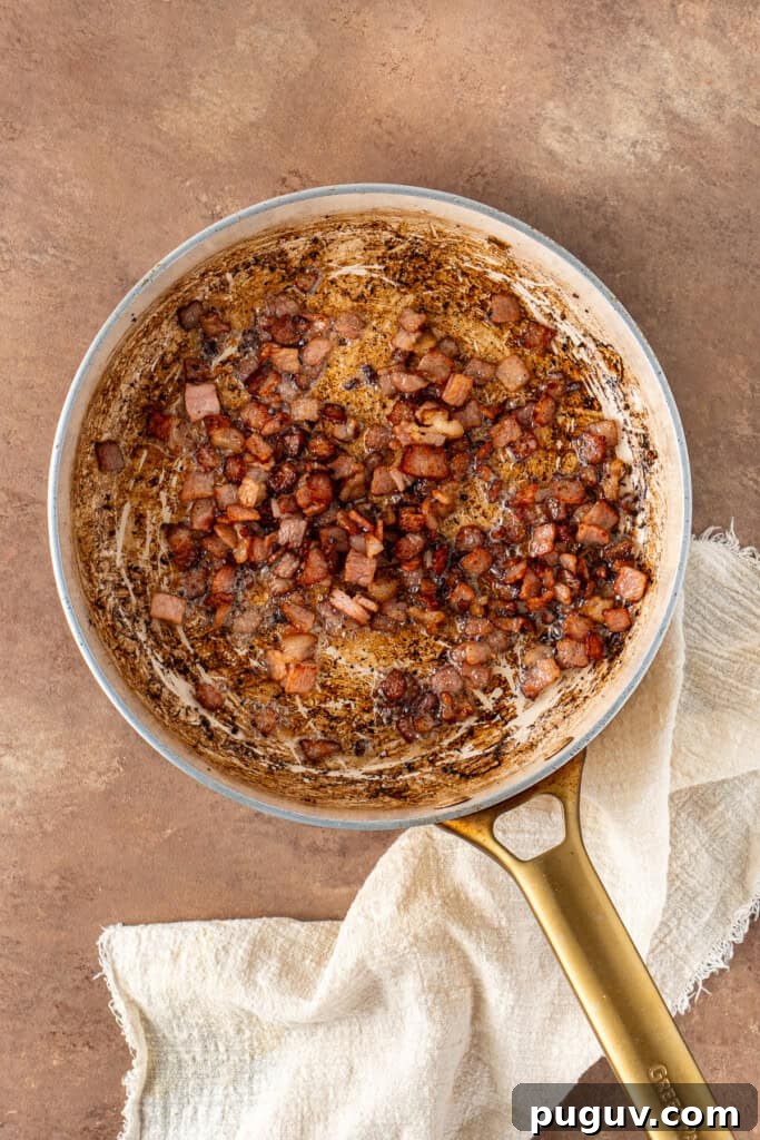 Creamy Dairy-Free Baked Potato Soup Recipe 7 Frying the bacon pieces in a frying pan.