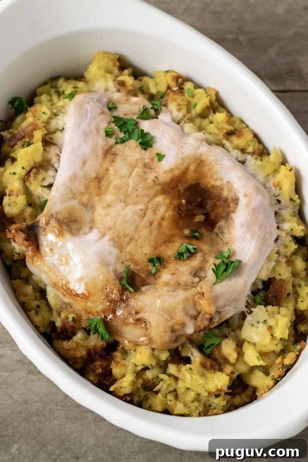 Baked Pork Chops and Stuffing in an individual white baking dish.