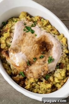 Baked Pork Chops and Stuffing in an individual white baking dish.