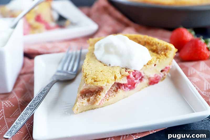 Red Fruit Custard Cake: Elegant Summer Dessert with Fresh Berries 10 Horizontal image of a slice of dessert filled with strawberry and raspberry topped with whipped cream on a white square plate next to a fork and pink napkin.