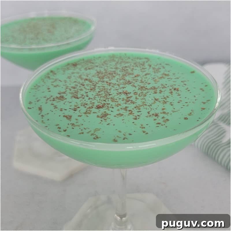 Christmas Cocktail Recipes Everyone Will Love 13 Green Grasshopper Cocktail with chocolate shavings as a garnish in a coupe glass