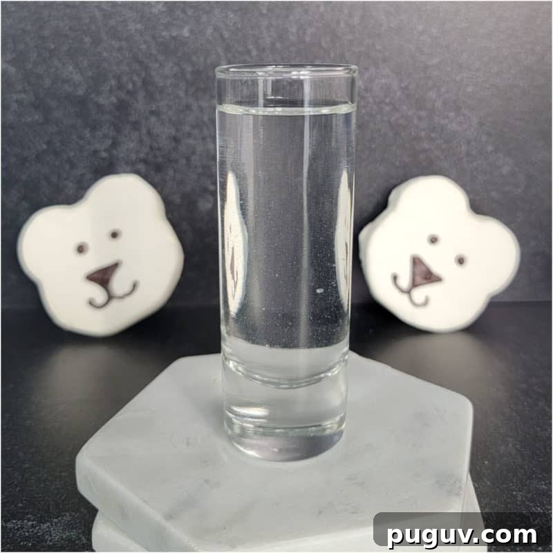 Christmas Cocktail Recipes Everyone Will Love 29 polar bear marshmallows behind a shot glass with clear liquid polar bear shot