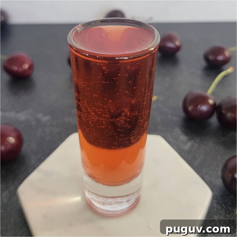 Christmas Cocktail Recipes Everyone Will Love 30 Red shot surrounded by cherries