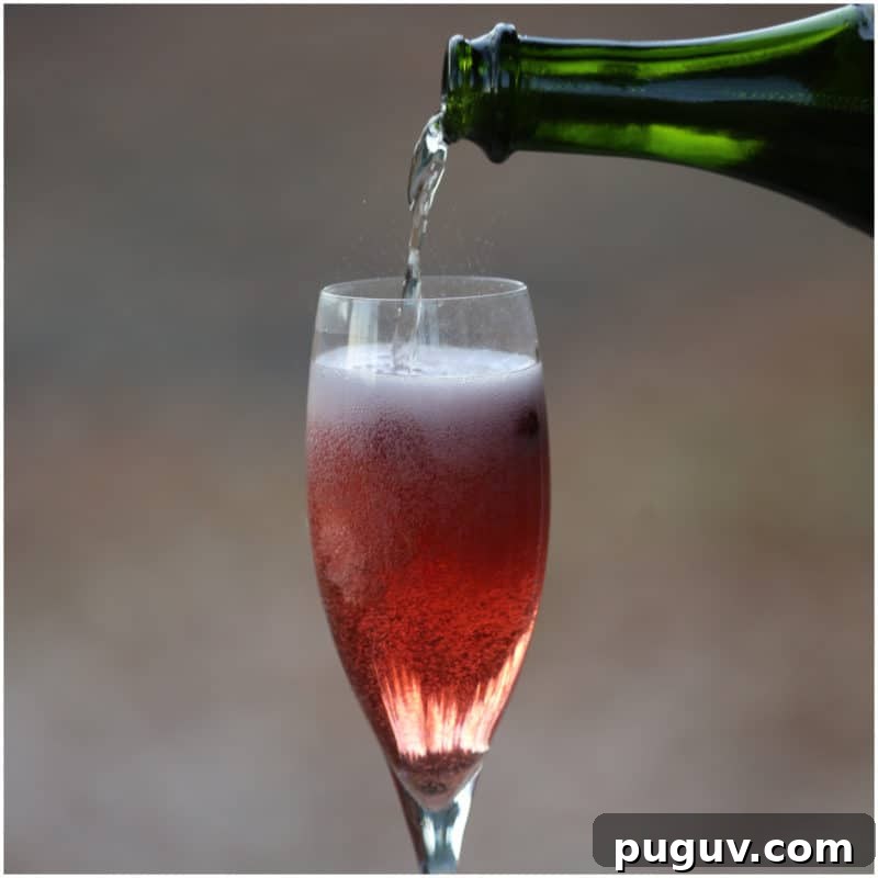 Christmas Cocktail Recipes Everyone Will Love 5 green champagne bottle pouring into a champagne flute with cranberry mimosa