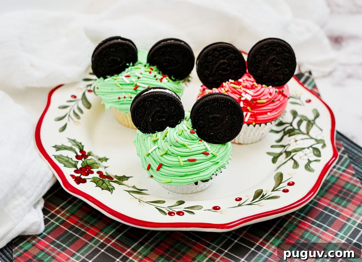 Plate with Mickey MOuse red and green christmas cupcakes.