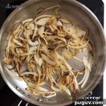 Fig Jam & Goat Cheese Burger Recipe for Sweet Savory Flavor 5 Onions caramelized in the frying pan.