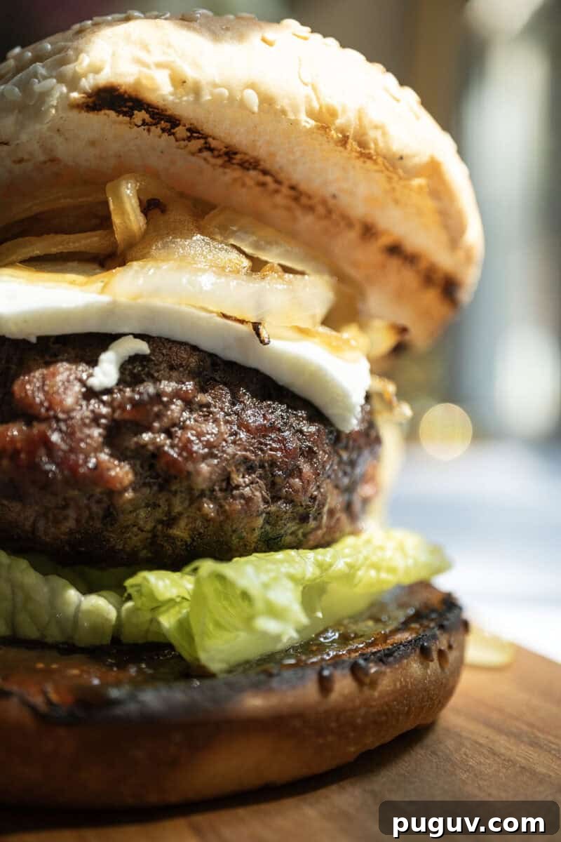 Fig Jam & Goat Cheese Burger Recipe for Sweet Savory Flavor 8 Burger on lettuce and fig jam topped with goat cheese and onions.