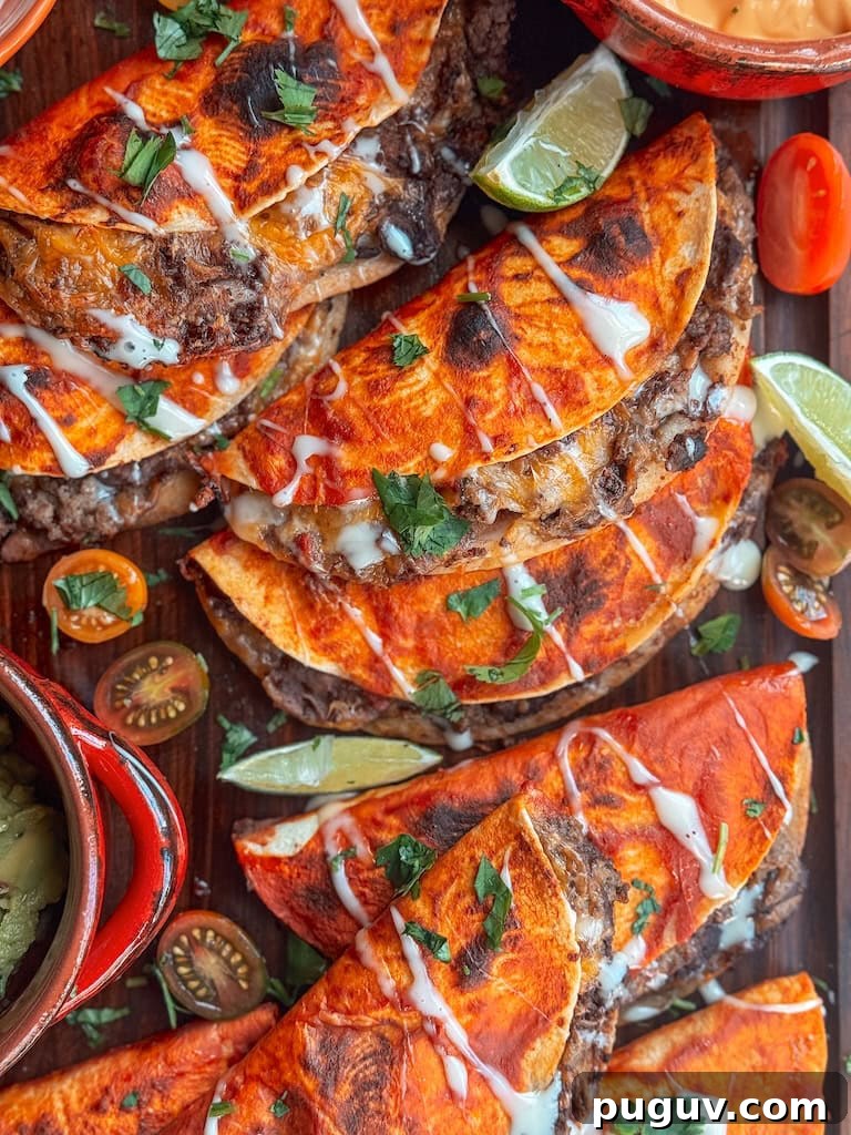 Baked beef and bean soft tacos with melted cheese and taco sauce