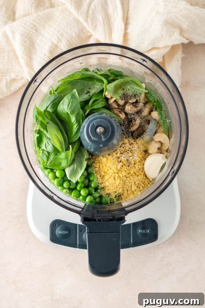 All pea pesto ingredients in a food processor.