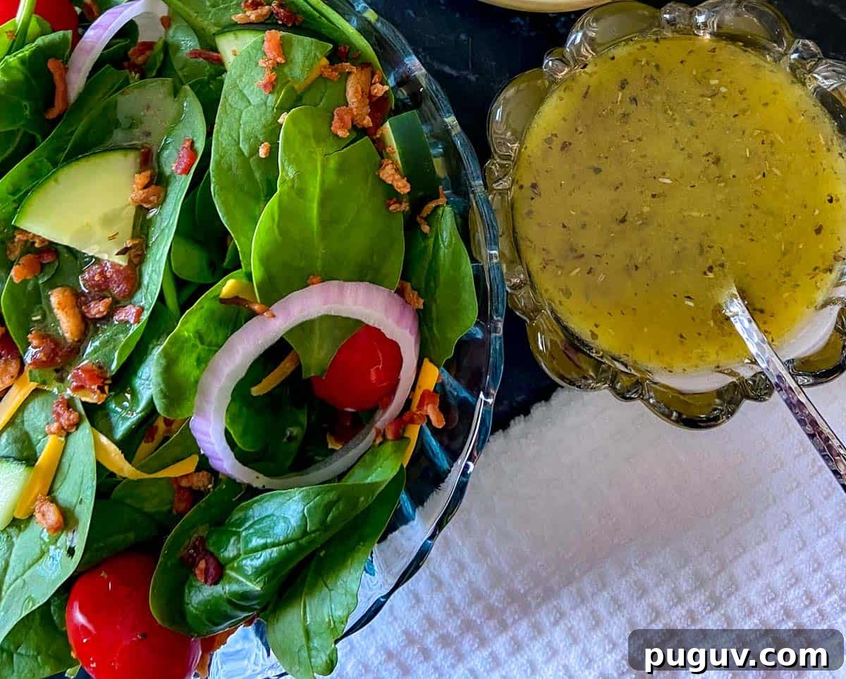 Low-Sodium White Balsamic Vinaigrette Recipe for Flavorful Salads 3 Spinach salad in a glass bowl with a side of White balsamic vinaigrette