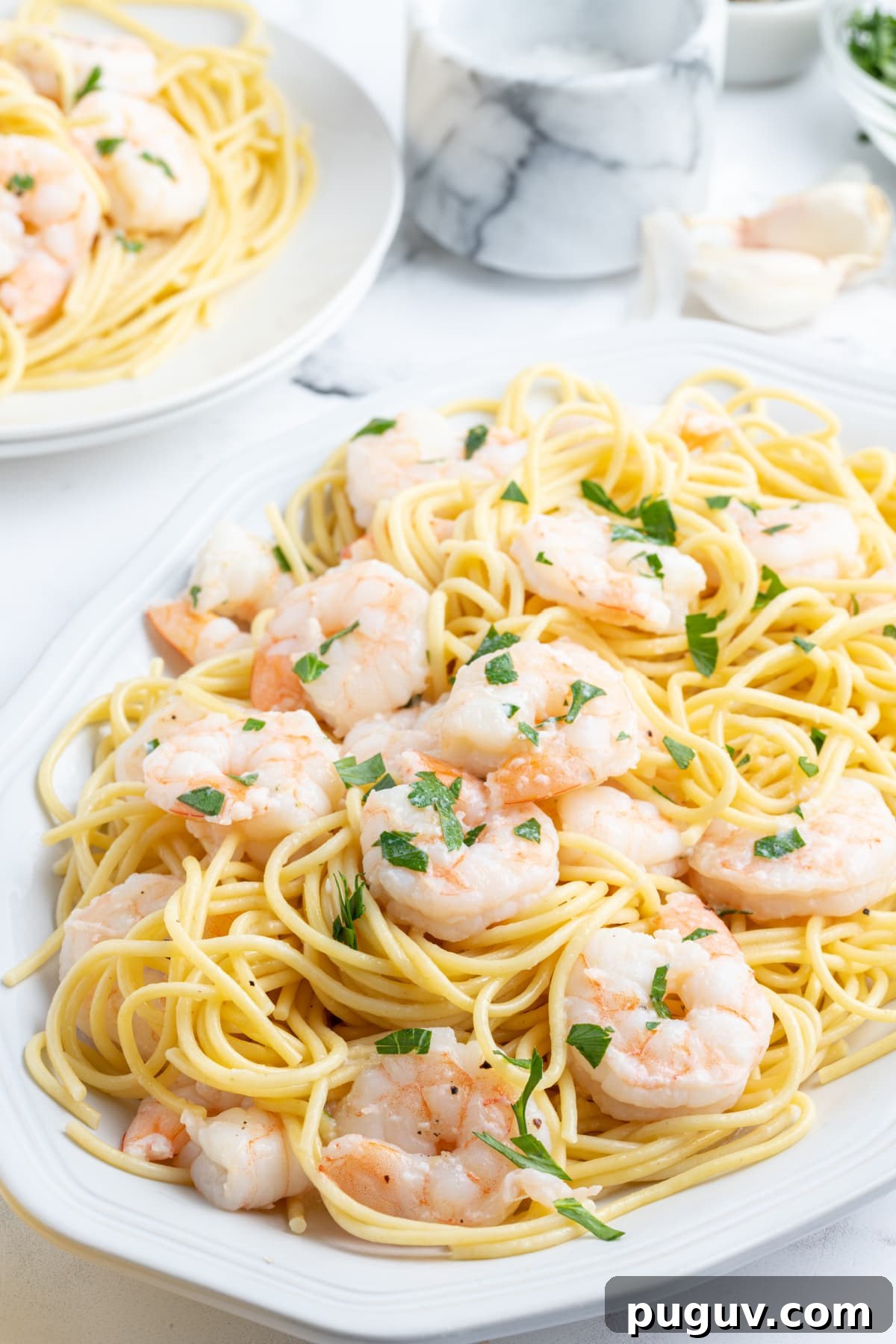 Shrimp Scampi served shrimp scampi over pasta on platter