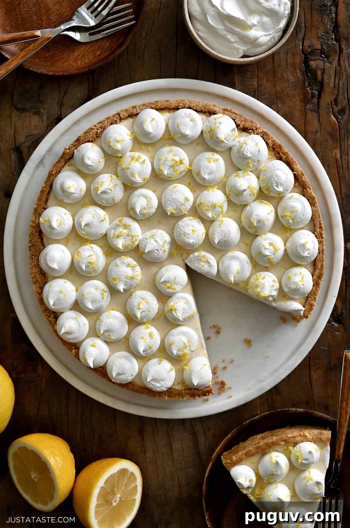 No-Bake Cheesecake Recipe: Creamy No-Bake Cheesecake Slice 7 A top-down view of a cheesecake topped with dollops of whipped cream and lemon zest.