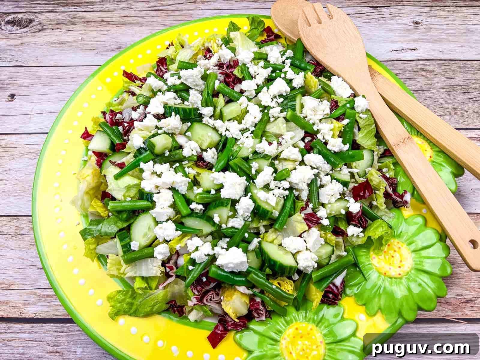 17 Low-Carb Meals That Keep You Full, Energized, and Ready 13 Mediterranean Chopped Salad with crumbled feta cheese, on a yellow plate with flower designs.