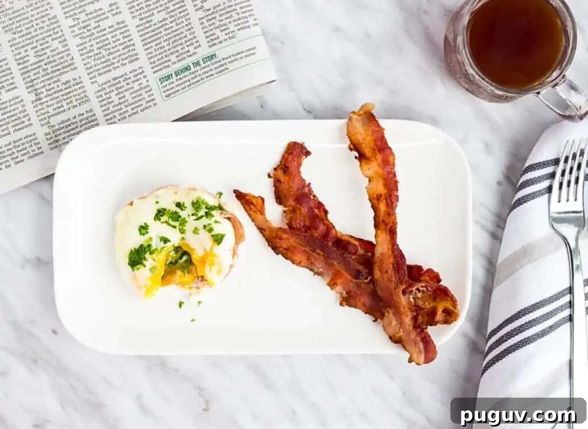 17 Low-Carb Meals That Keep You Full, Energized, and Ready 14 Bacon and eggs on a plate with a cup of coffee.