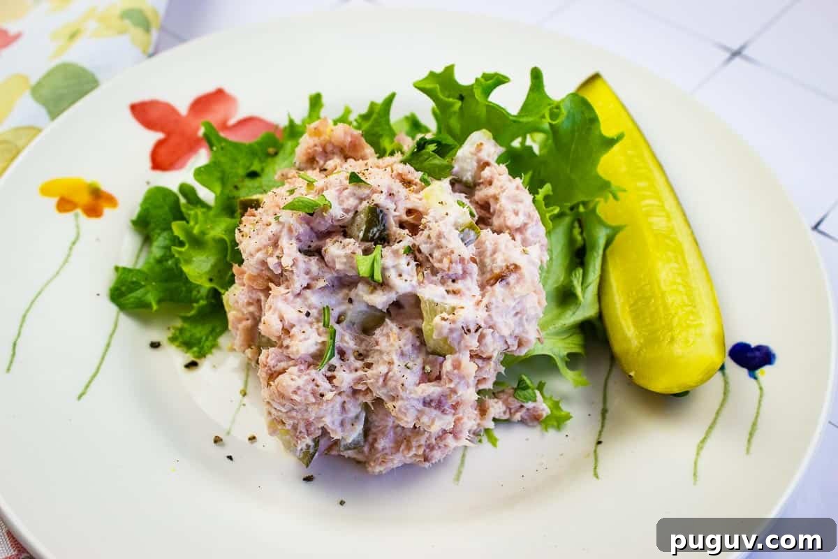 17 Low-Carb Meals That Keep You Full, Energized, and Ready 16 Ham Salad with dill pickle on a plate.