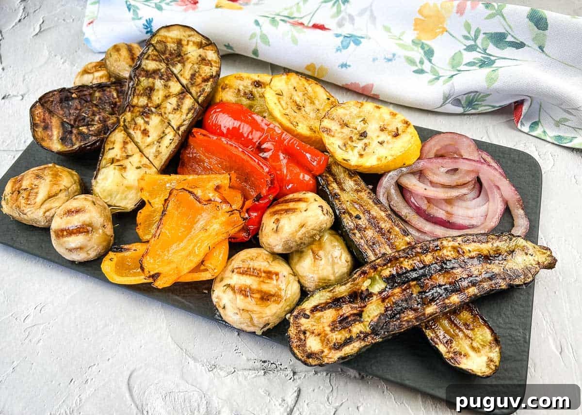 17 Low-Carb Meals That Keep You Full, Energized, and Ready 18 Grilled vegetables including zucchini, mushrooms, red onions, peppers, and squash, arranged on a rectangular black platter.