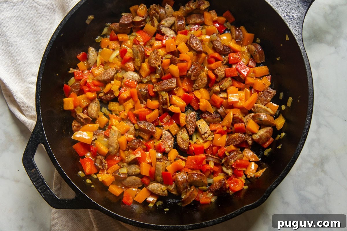 Sausage and Pepper Pasta Recipe — Quick Weeknight Dinner 5 a pan of sausage and peppers cooked together.