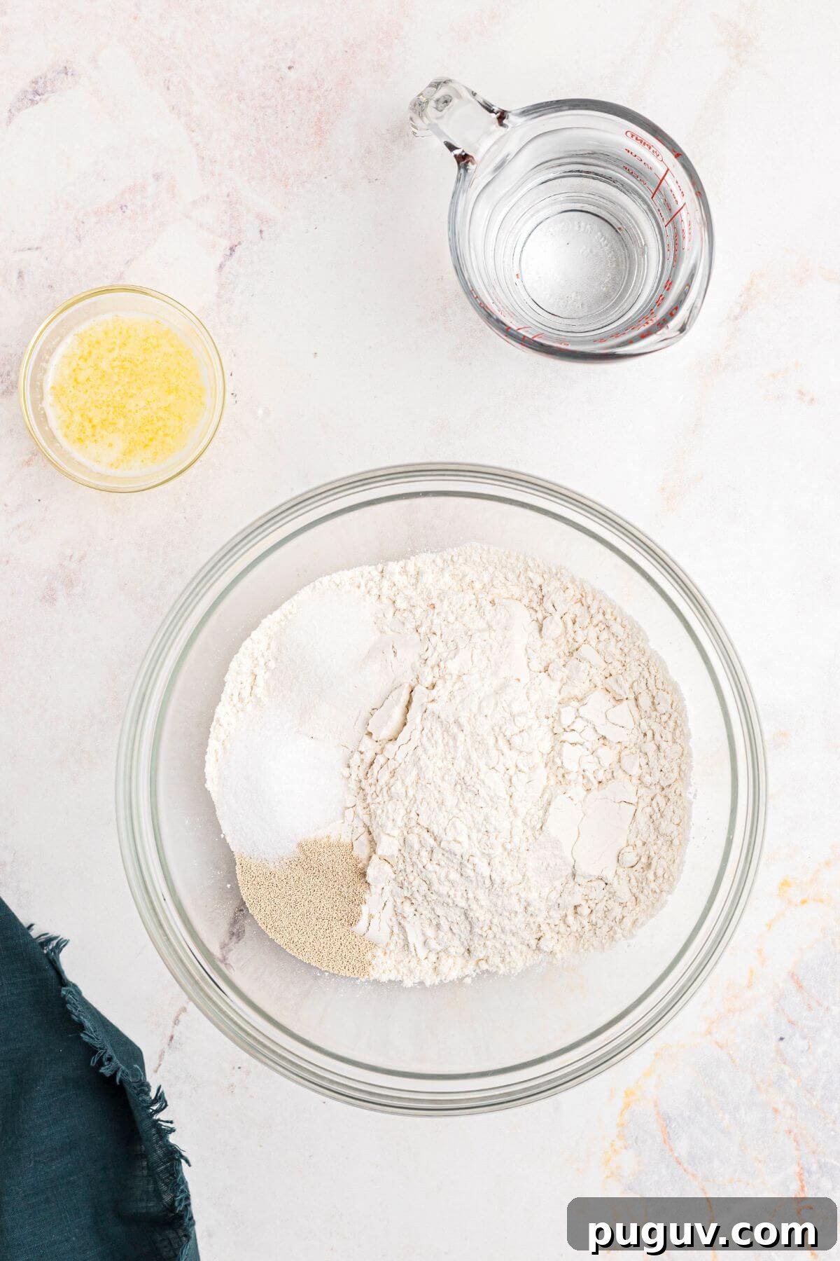 Crispy-On-The-Outside, Soft-On-The-Inside Air Fryer Pretzels 4 Flour, salt and yeast being mixed in a clear glass bowl.