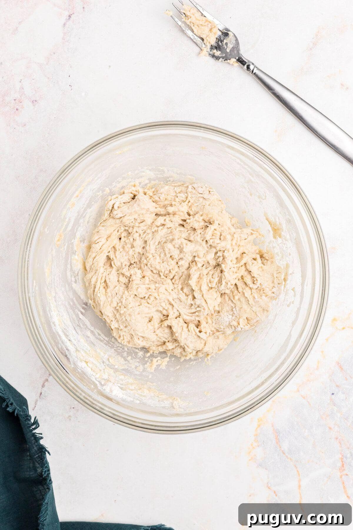 Crispy-On-The-Outside, Soft-On-The-Inside Air Fryer Pretzels 5 Dough mixed together in a clear glass bowl.
