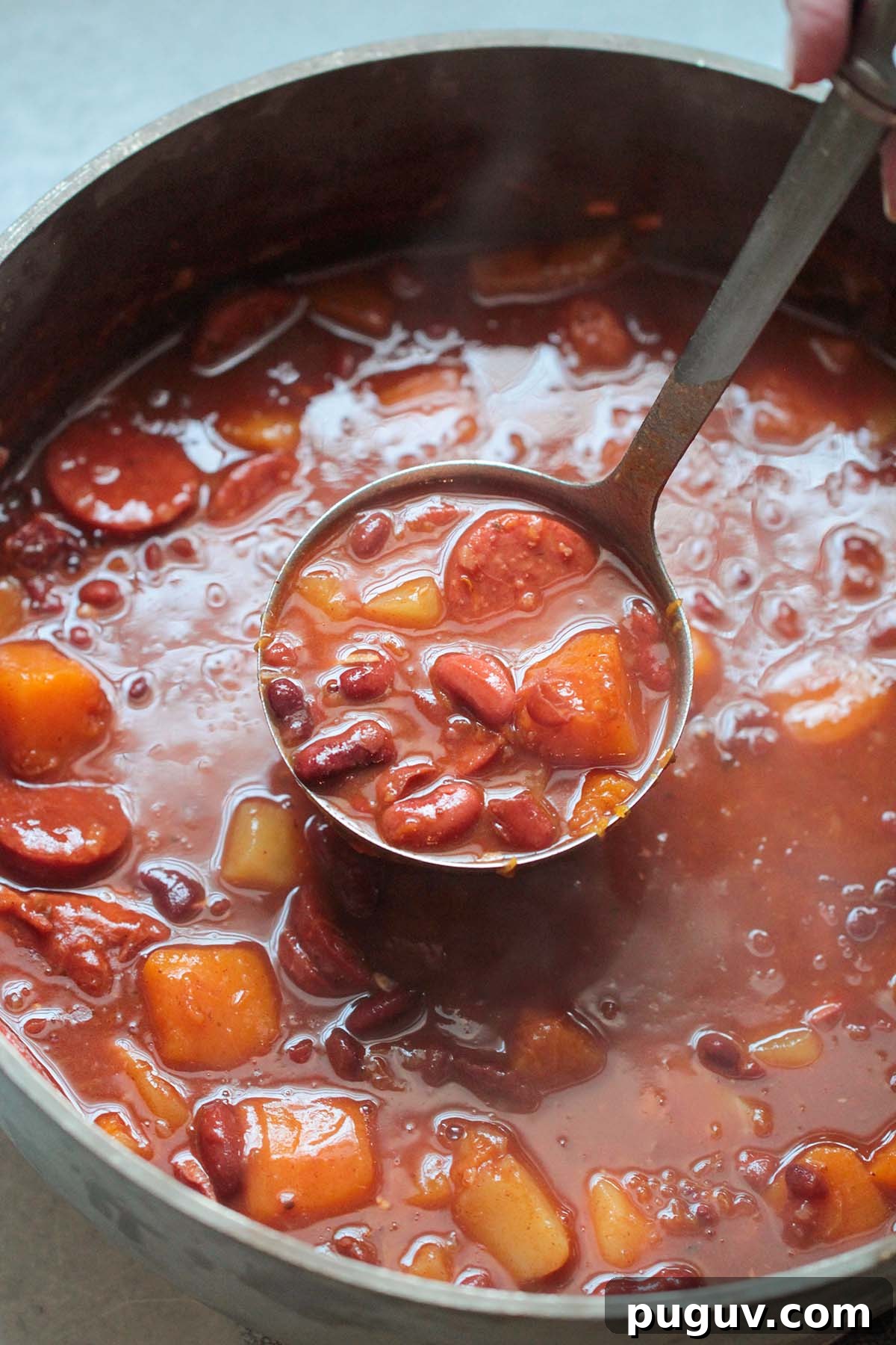 Cuban red beans in a large pot with a ladle.