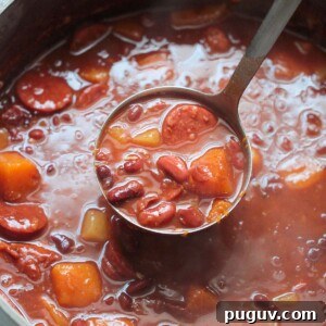 Cuban red beans in a large pot with a ladle.