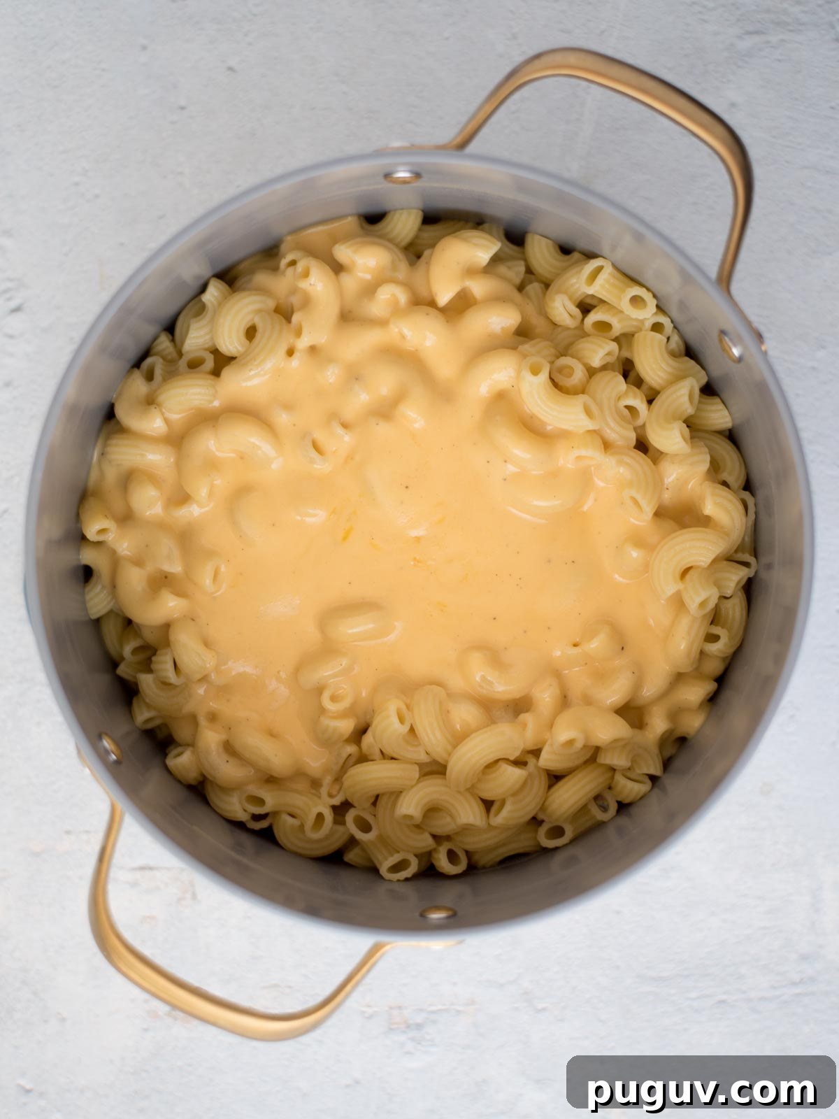 Creamy Baked Macaroni and Cheese Casserole 8 Cheese sauce placed over cooked pasta in a saucepan.