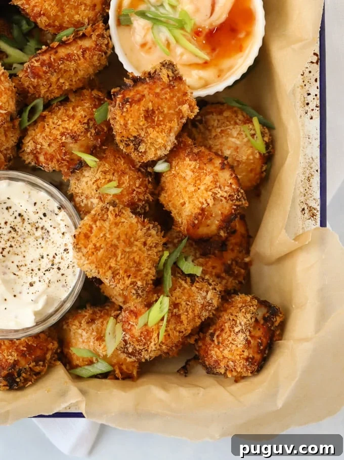 Crispy Homemade Chicken Nuggets Recipe for Family Meals 3 Homemade chicken nuggets coated in breadcrumbs with dipping sauces.
