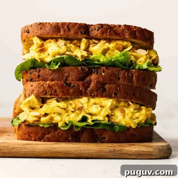 Crispy Homemade Chicken Nuggets Recipe for Family Meals 10 Two sandwiches filled with Coronation Chicken and lettuce, one of top of the other on a chopping board.