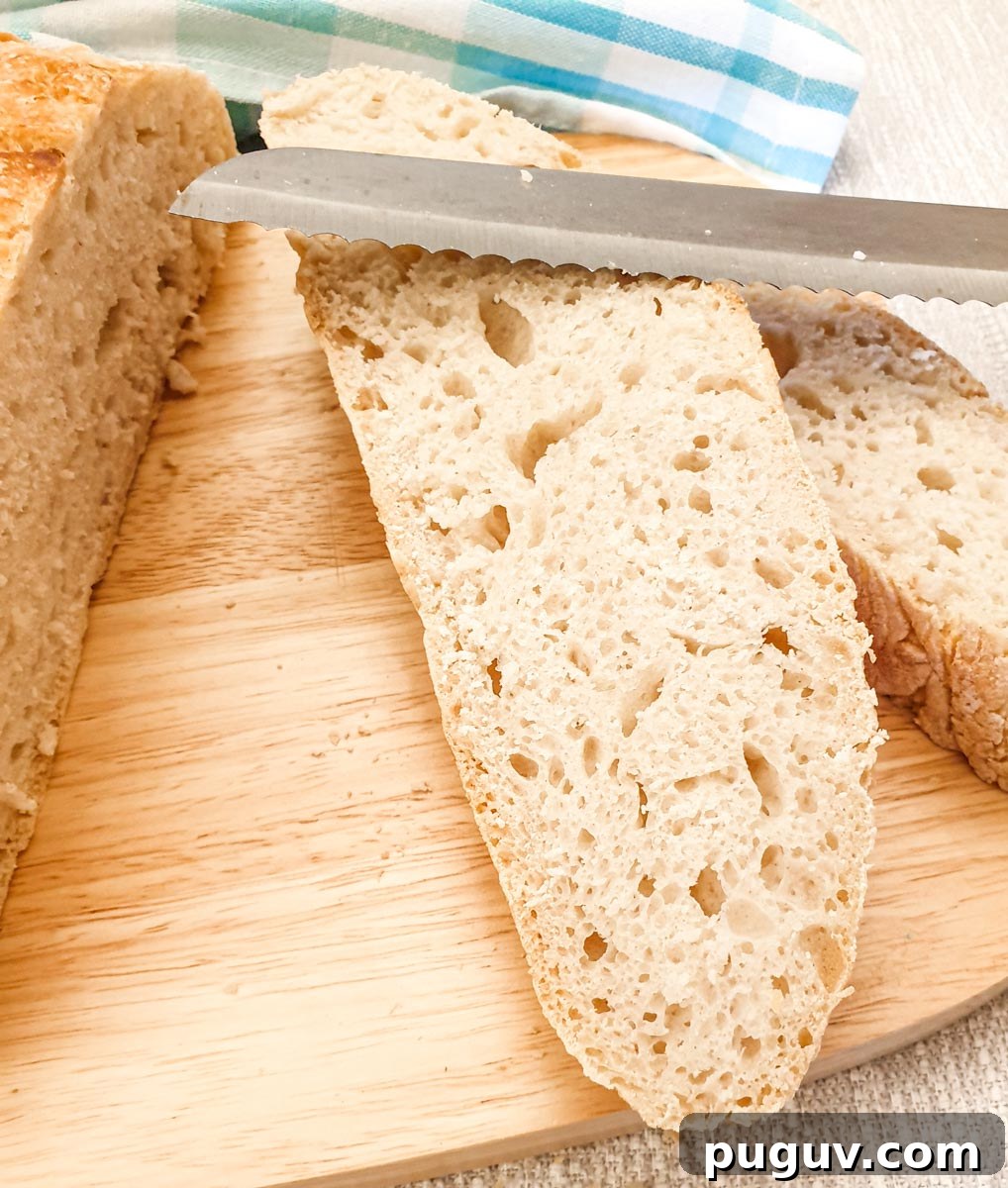 No-Knead Crusty Homemade Bread Recipe for Perfect Loaves 3 Slices of bread cut from the crusty homemade loaf.