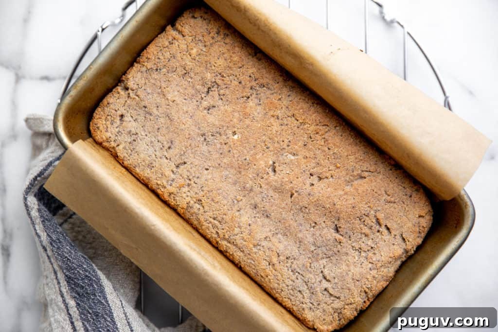 No-Yeast Vegan Almond Bread (Grain-Free, Paleo Recipe) 6 The baked loaf of bread in a parchment-lined pan.