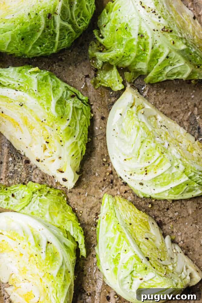 Crispy Roasted Cabbage with Olive Oil and Sea Salt 4 Savoy cabbage cut into wedges on parchment paper with olive oil, salt and pepper