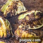 Crispy Roasted Cabbage with Olive Oil and Sea Salt 5 Deeply charred roasted cabbage wedges on a dark sheet pan