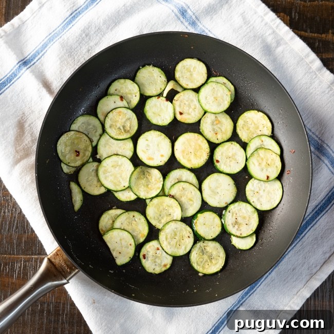 10-Minute Sautéed Zucchini with Fresh Herbs and Lemon Zest 4 Slices of zucchini in a skillet after being sautéed.