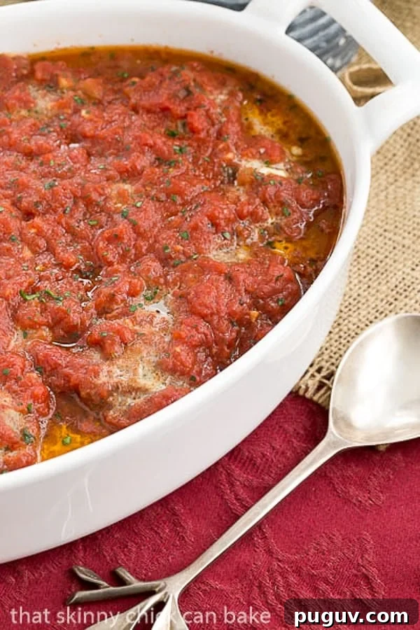Mozzarella Stuffed Meatballs - Tender meatballs filled with gooey mozzarella Mozzarella Stuffed Meatballs in a white casserole dish.