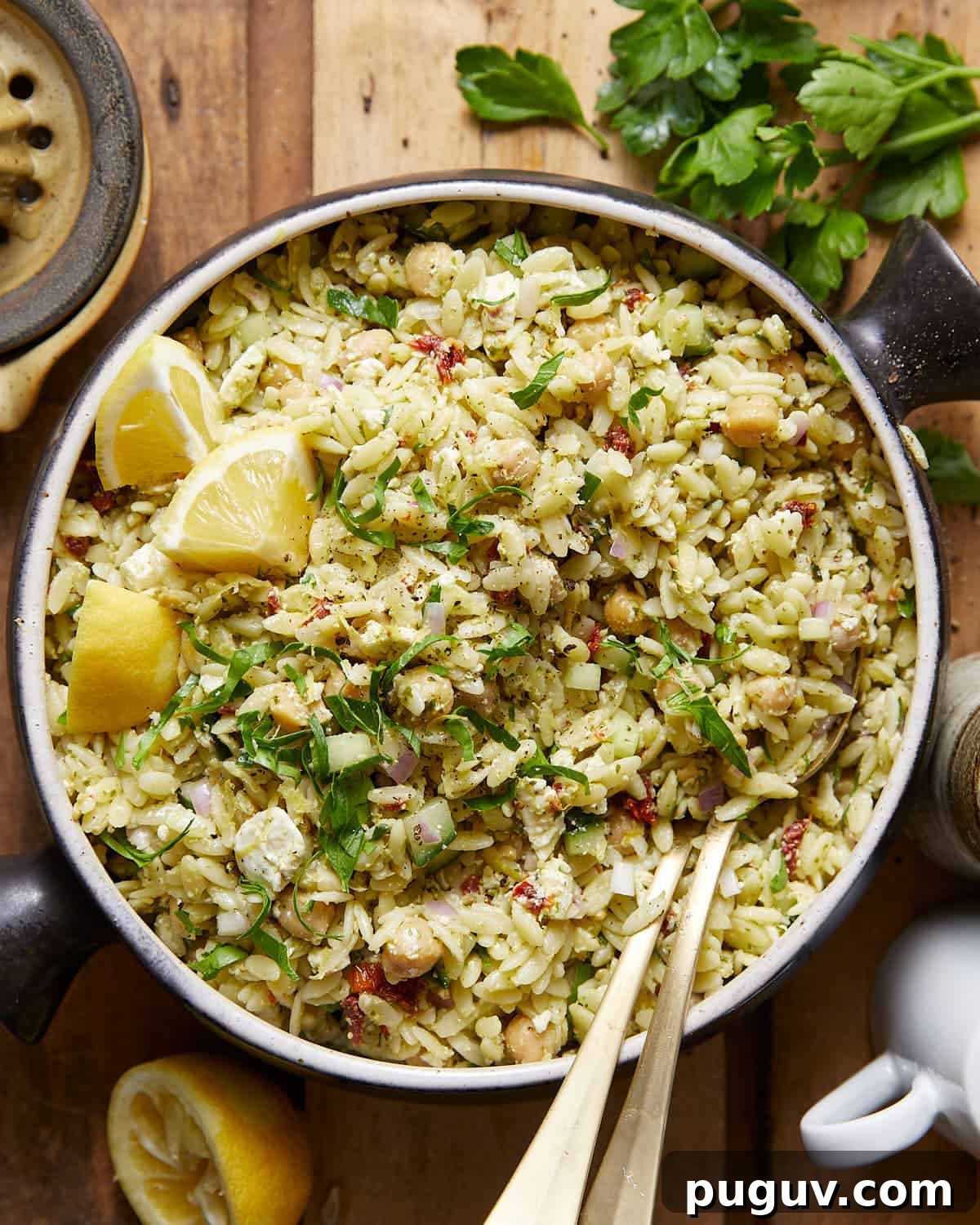An overhead image of pesto orzo salad with garnish.