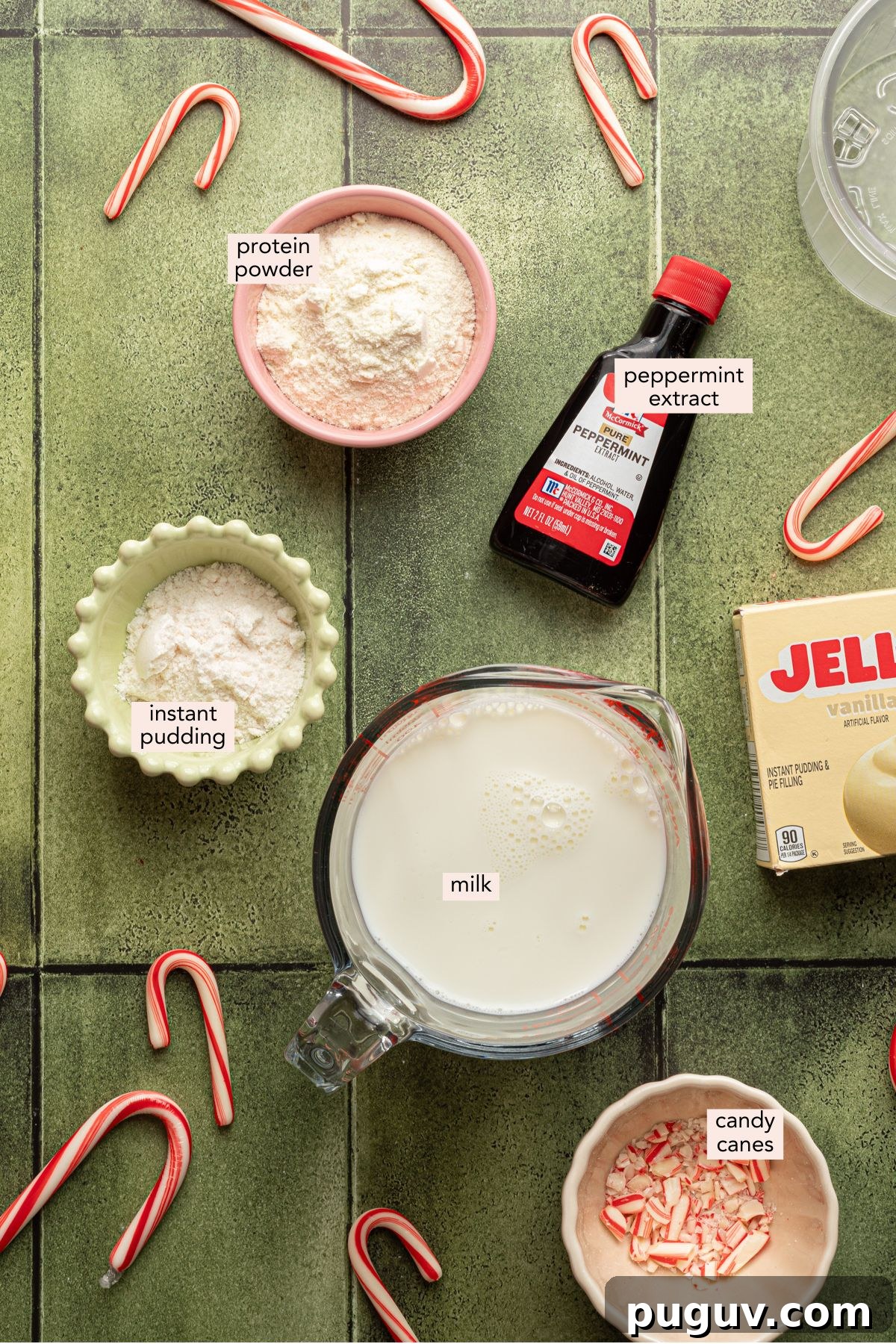 Ninja Creami peppermint ice cream ingredients on a green counter top in individual containers.