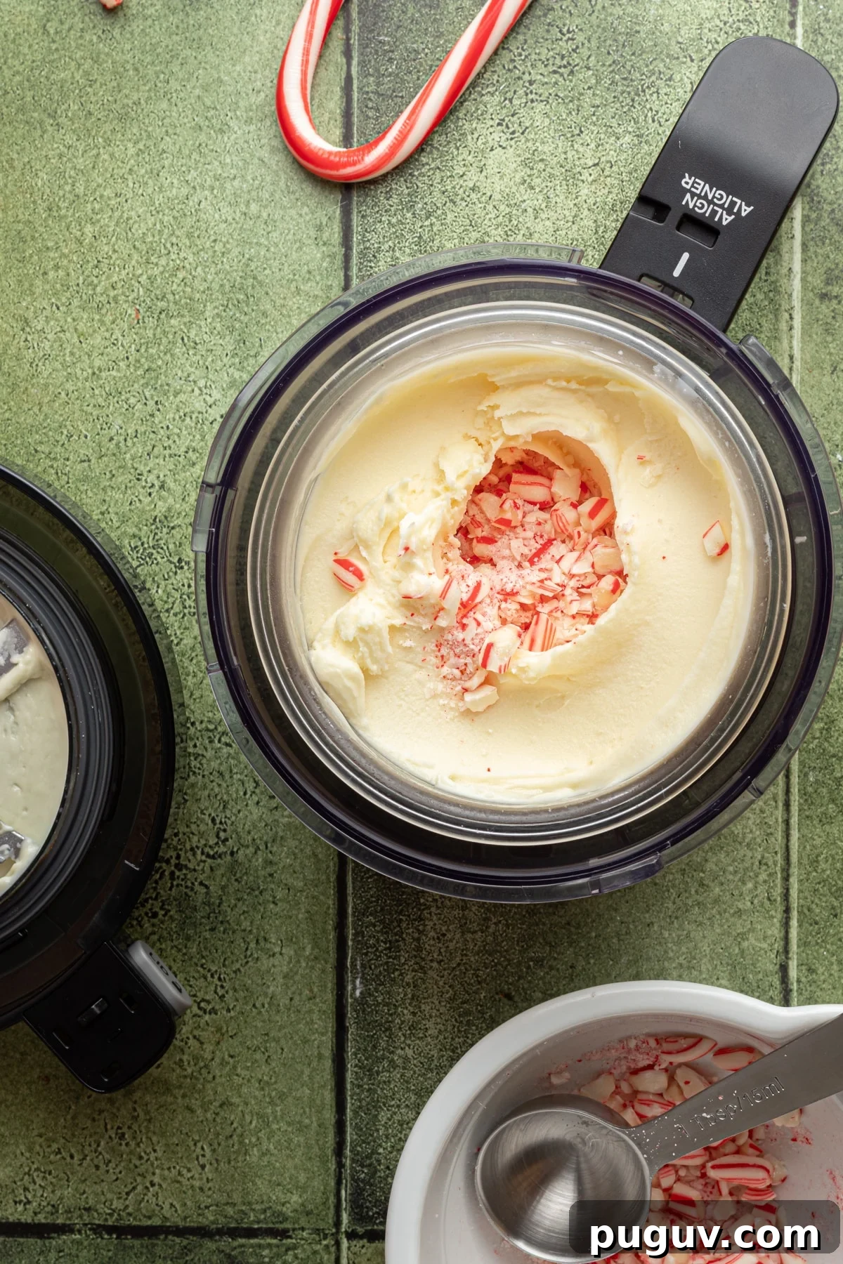 Ninja Creami ice cream base after initial spins with a hole in the center filled with crushed peppermints.