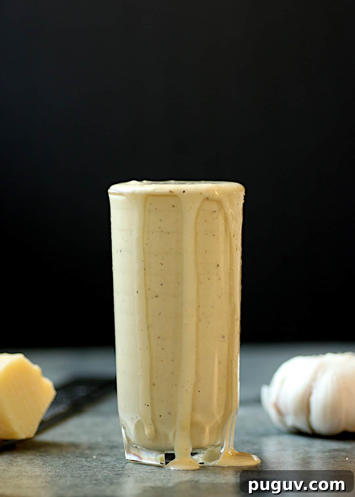 Basil Balsamic Vinaigrette Recipe — Tangy Herb Dressing for Salads 8 A glass filled to the brim with homemade caesar salad dressing.