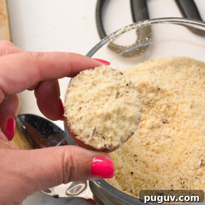 Toss the potato halves in avocado oil. Then dip the cut edge into the Parmesan mixture, ensuring each piece is evenly coated.