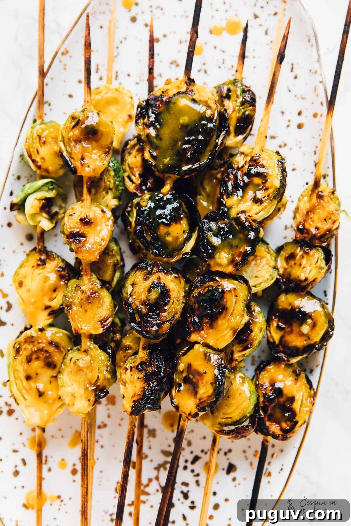 Grilled Brussels Sprouts with Maple Mustard Glaze 2 Top down shot of grilled maple mustard brussels sprouts on skewers.