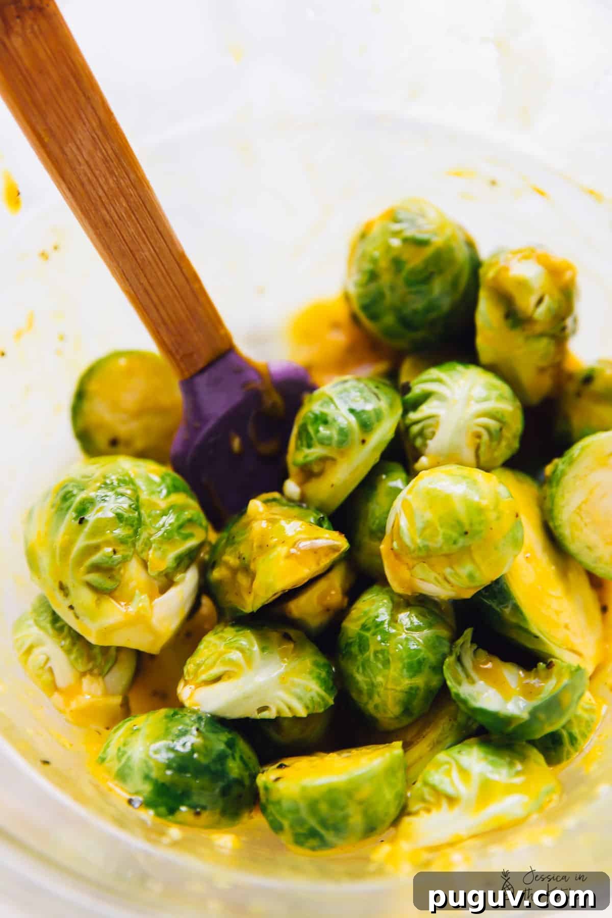Grilled Brussels Sprouts with Maple Mustard Glaze 4 Mixing brussels sprouts with maple mustard dressing.