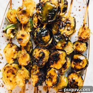 Overhead shot of grilled on skewers. maple mustard brussels sprouts.