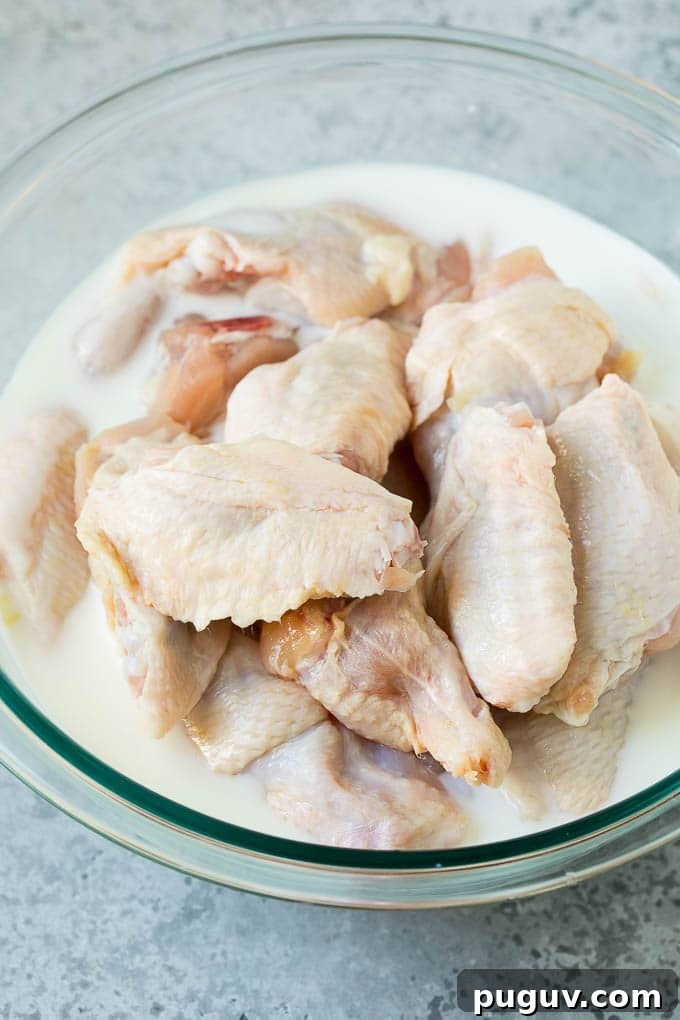 Chicken wings in buttermilk Chicken wings in a bowl of buttermilk.