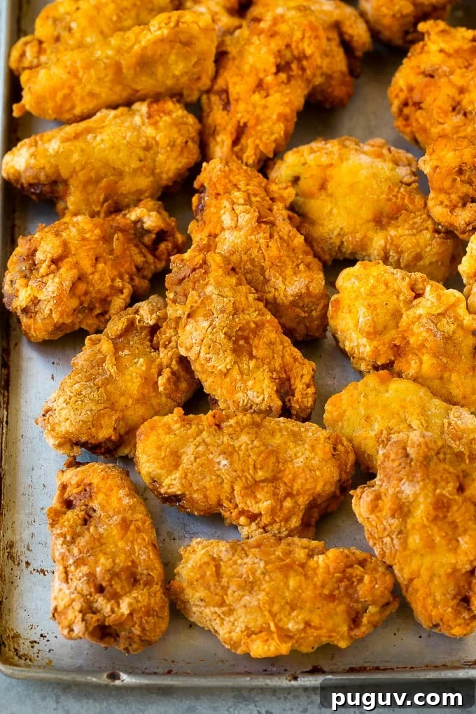 Fried wings on sheet pan Deep fried wings on a sheet pan.