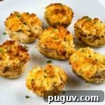 Crispy air fryer stuffed mushrooms on a white serving platter.