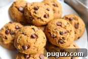 Pumpkin Chocolate Chip Cookies Made from Cake Mix 9 large pumpkin chocolate chip cookies on a white plate