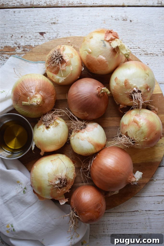 Perfect Guide to Caramelizing Onions for Sweet, Golden Flavor 4 onions on a wooden board to make caramelized onions