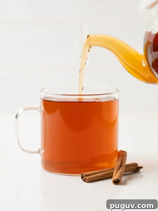 cinnamon tea pouring into a mug