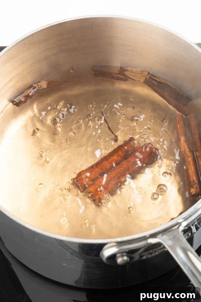 Cinnamon sticks boiling with water.