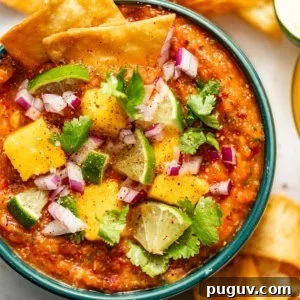 Mango Habanero Salsa Recipe — Sweet Heat with Fresh Mango 12 mango habanero salsa in a bowl surrounded by tortilla chips and sliced limes.